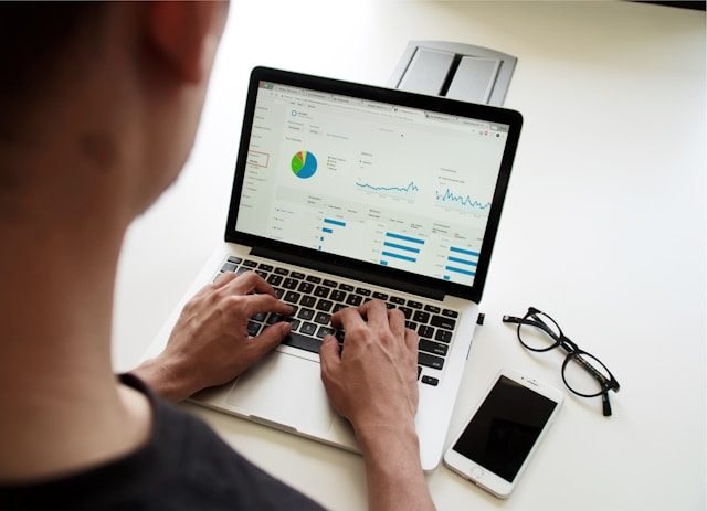 Person arbeitet an einem Laptop mit Diagrammen